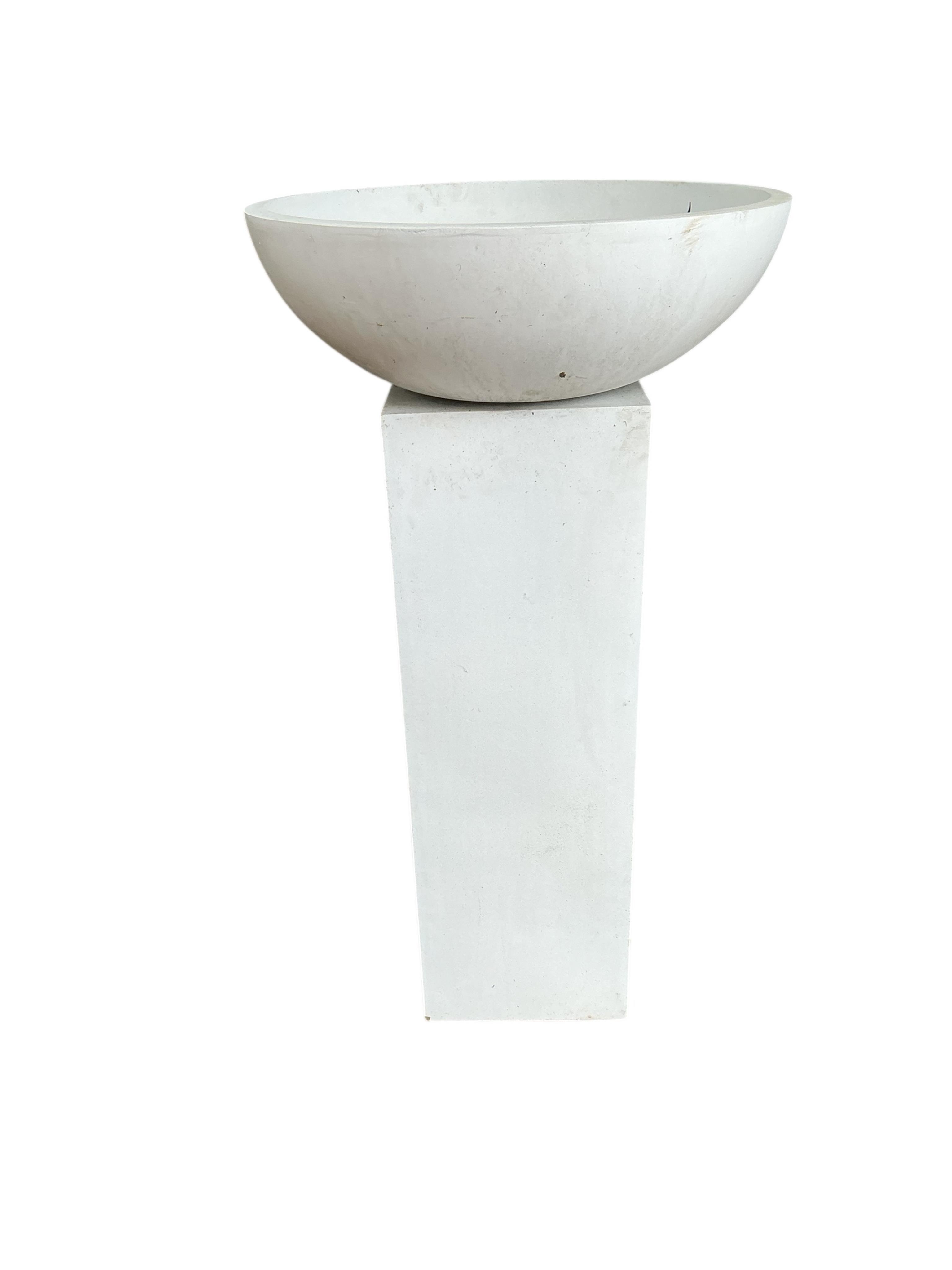 A pair of contemporary circular composition planters on square pedestal bases, diameter 60cm, height 112cm